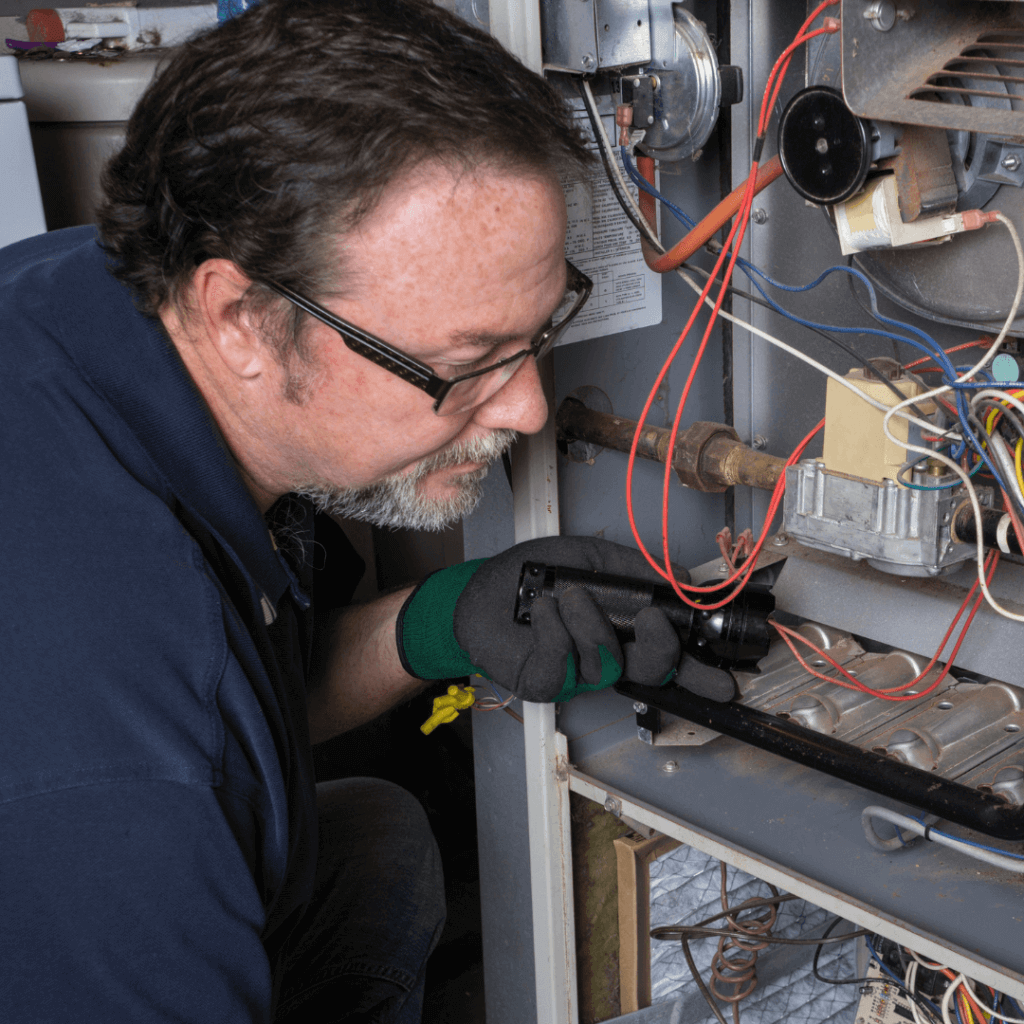 a mechanic repairing a furnace
